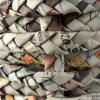 The basket from paper-tubes woven into tresses - details.